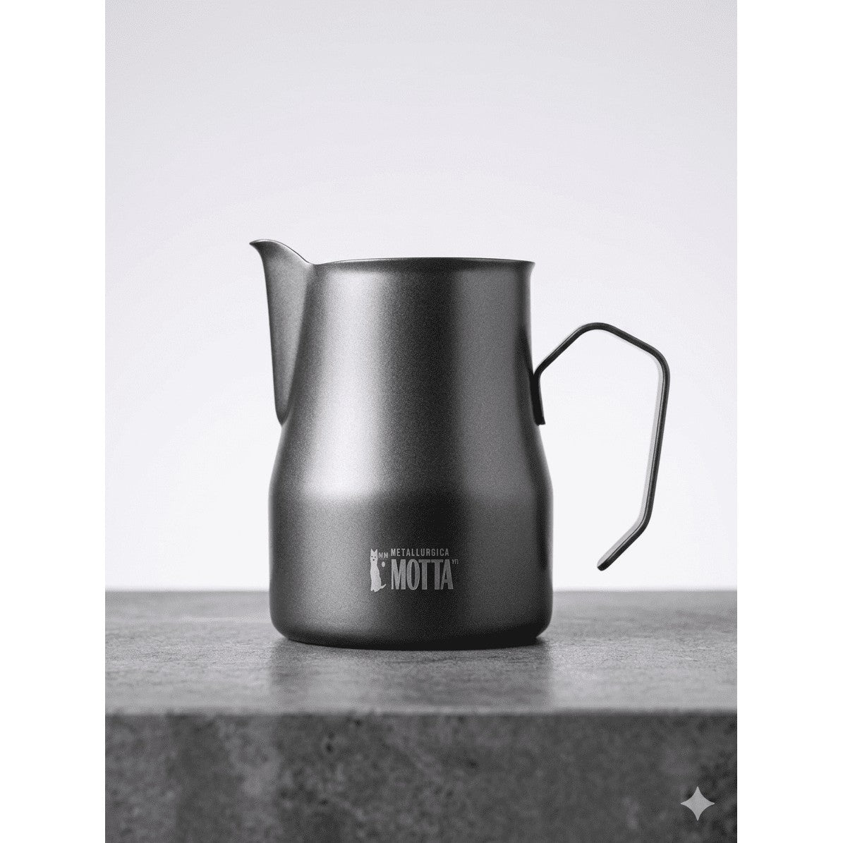 Dark Motta 350ml stainless steel milk pitcher on a stone surface