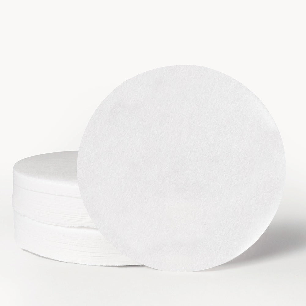 Stack of round Aeropress paper micro-filters on white background
