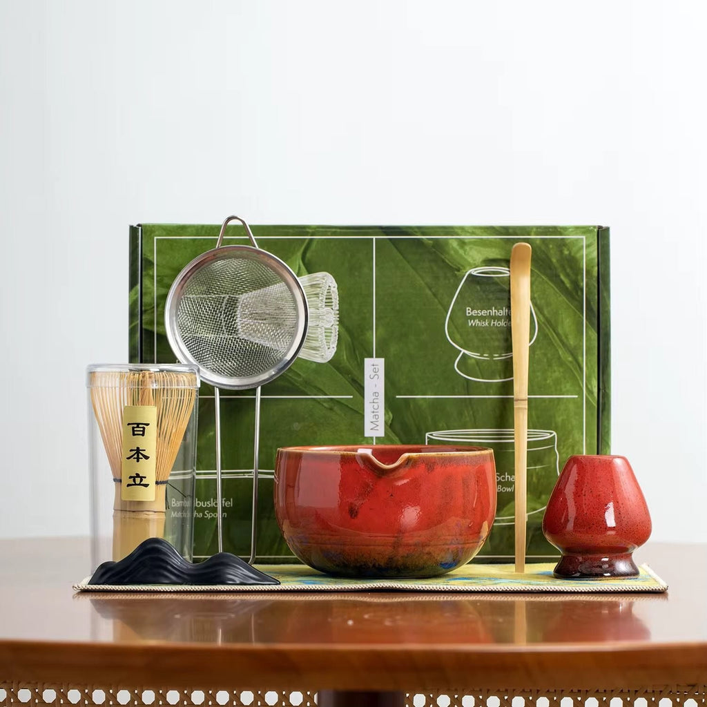 Seven-piece matcha preparation set with red ceramic bowl, bamboo whisk and tools